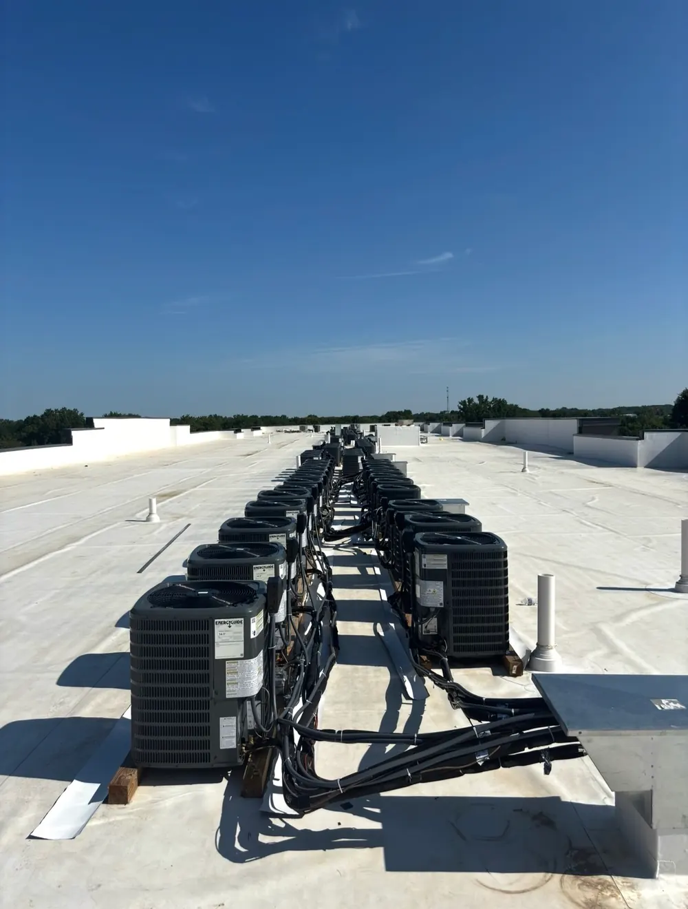 Row of outdoor condensing units on a commercial membrane roof