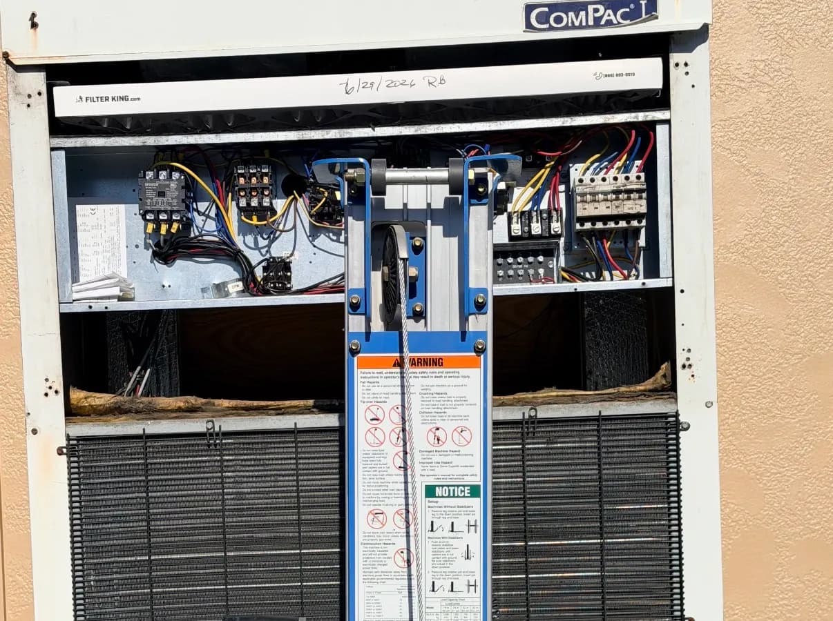 Open control panel on a Marvair ComPac unit serviced by Prime Guard, with a dated filter service tag.