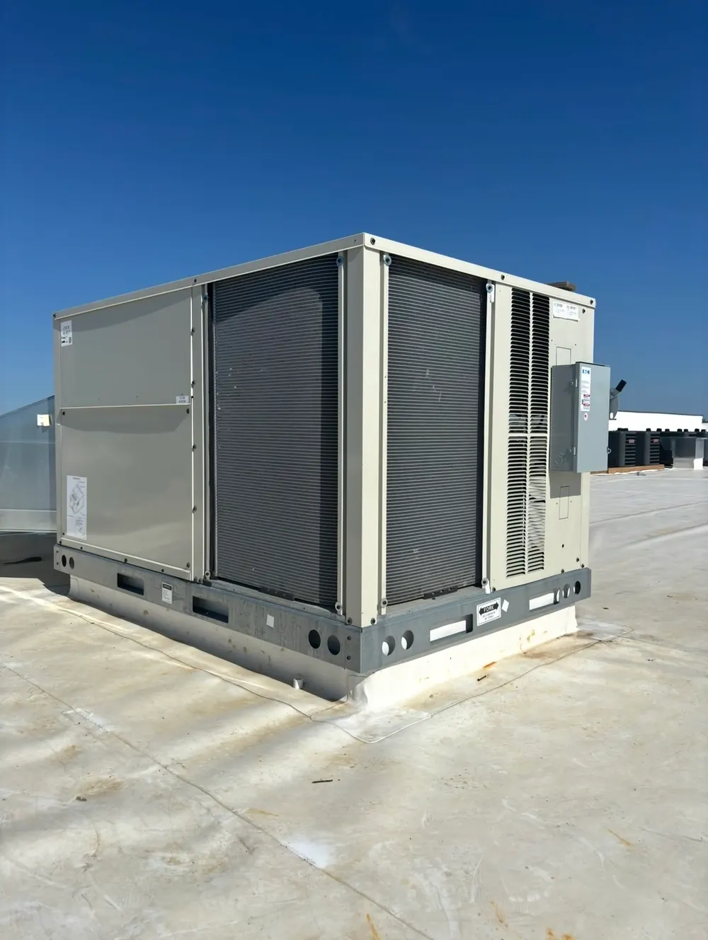 Packaged rooftop unit on a curb with flashing and an exterior disconnect